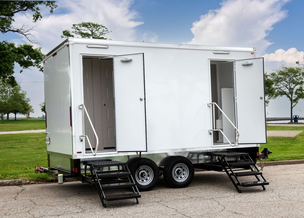 Two-station restroom trailer with doors open